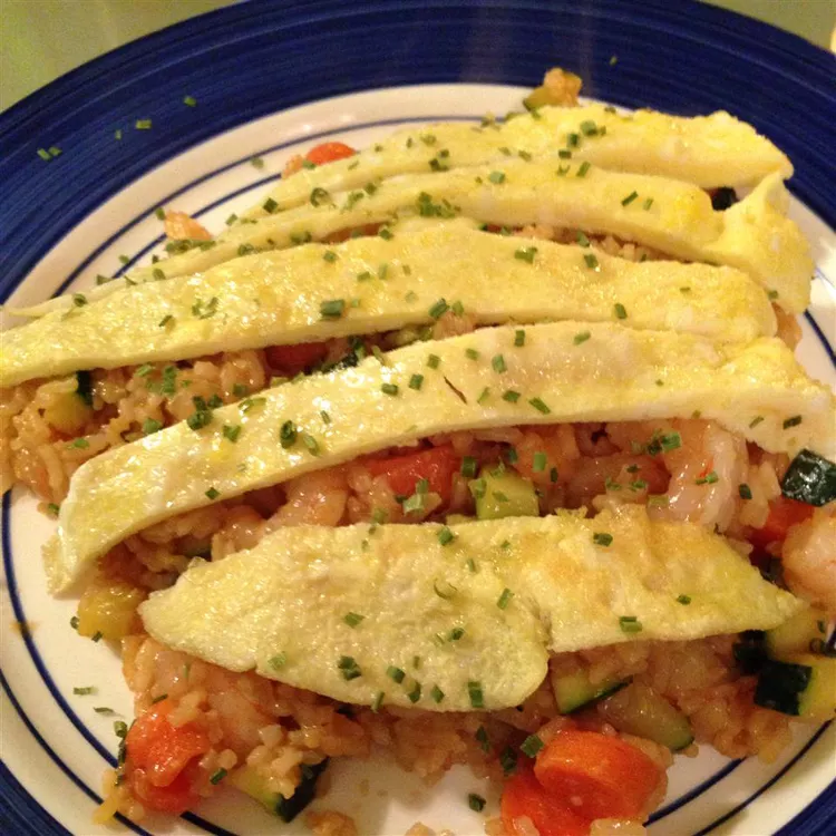 Delicous nasi goreng with cooked egg strips on top